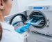 Dentist placing instrument in Autoclave for Sterilisation